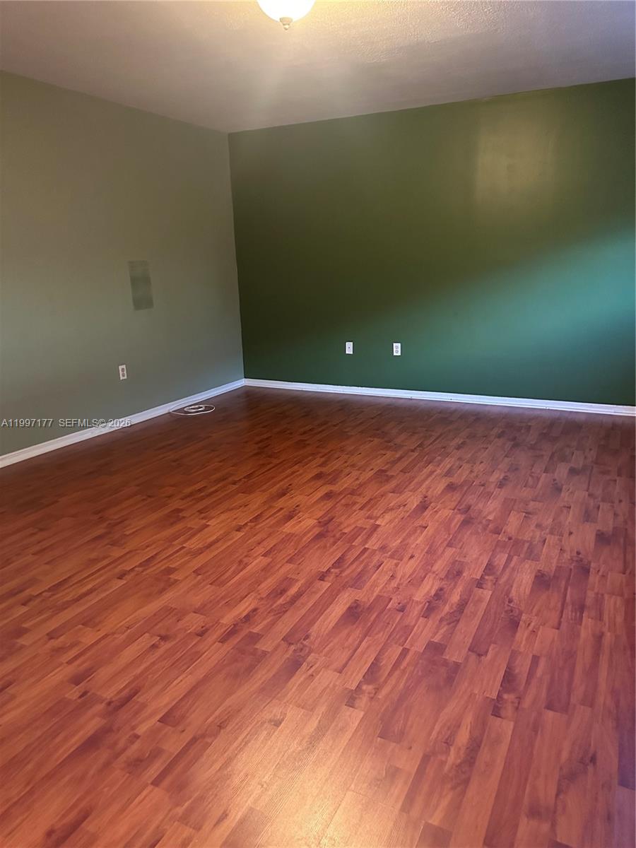 9724 Southwest 142nd Place Miami, FL 33186 - Photo 25 of 36 a view of a room with wooden floor and fan