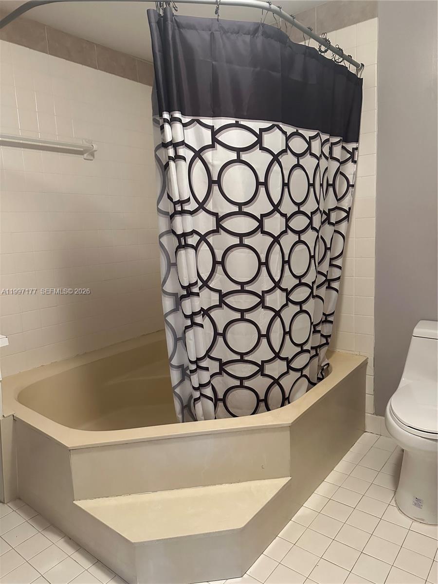 9724 Southwest 142nd Place Miami, FL 33186 - Photo 26 of 36 a bathroom with a bathtub and toilet