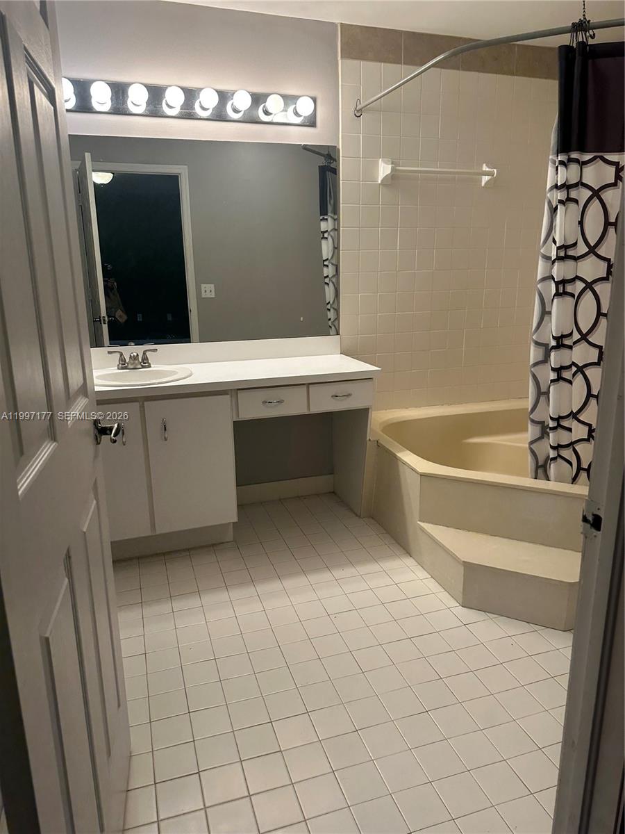 9724 Southwest 142nd Place Miami, FL 33186 - Photo 27 of 36 a bathroom with a sink vanity and mirror