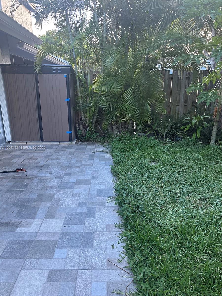 9724 Southwest 142nd Place Miami, FL 33186 - Photo 28 of 36 a view of a backyard with plants and large trees
