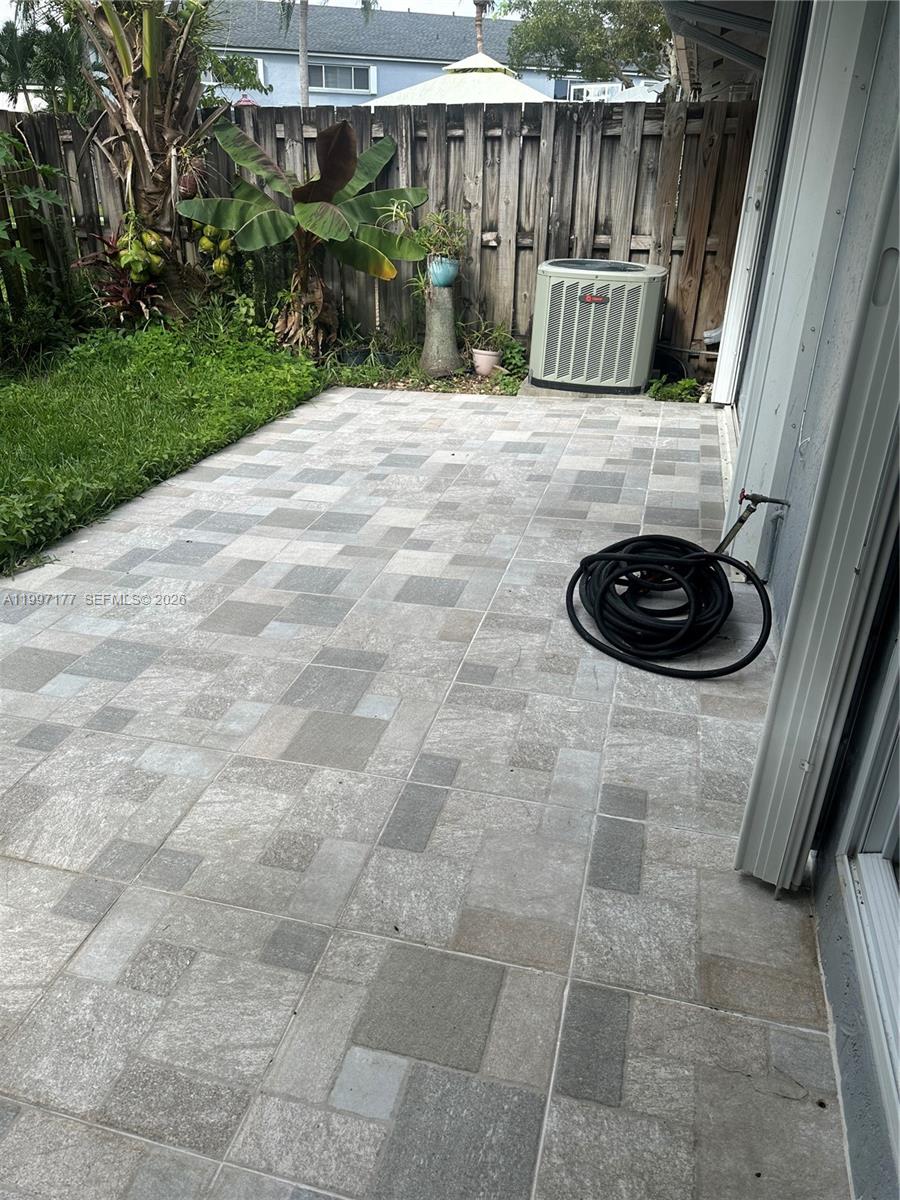 9724 Southwest 142nd Place Miami, FL 33186 - Photo 29 of 36 a backyard of a house with table and chairs