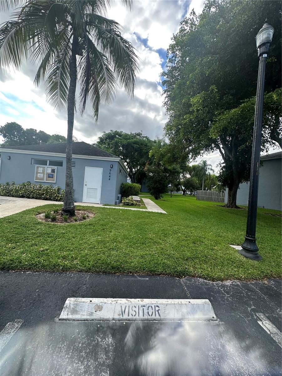 9724 Southwest 142nd Place Miami, FL 33186 - Photo 35 of 36 a front view of a house with a yard and garage