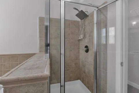 a bathroom with a glass shower door