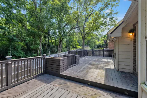 a view of a wooden deck and a backyard
