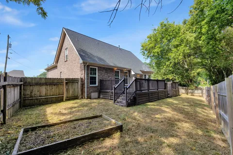 a view of a house with a yard and roof
