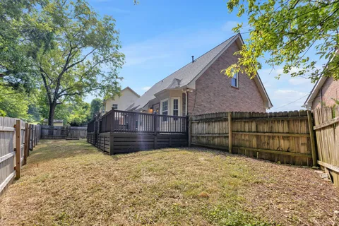 a view of a house with a yard covered in snow