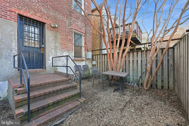 a view of two chairs in a backyard