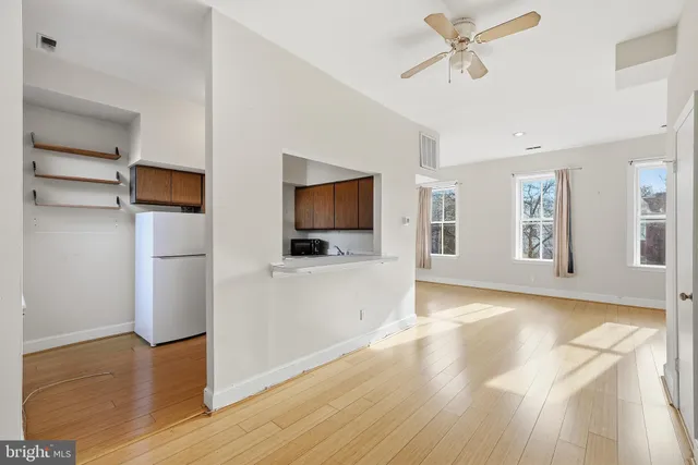 a view of a livingroom with an empty space and a window