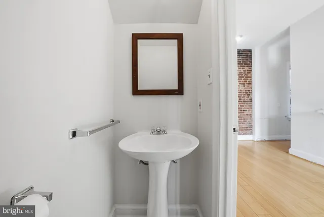 a bathroom with a sink a mirror and a shower