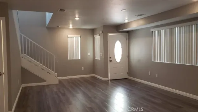 a view of entryway with stairs and wooden floor