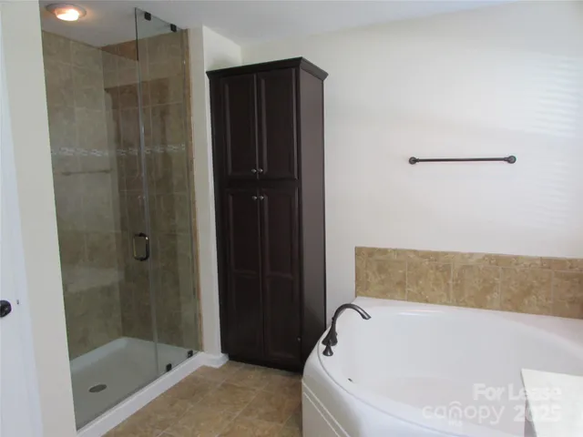 a bathroom with a bathtub and shower