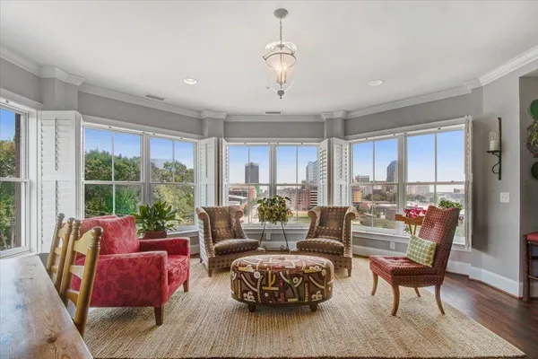 a living room with furniture and wooden floor