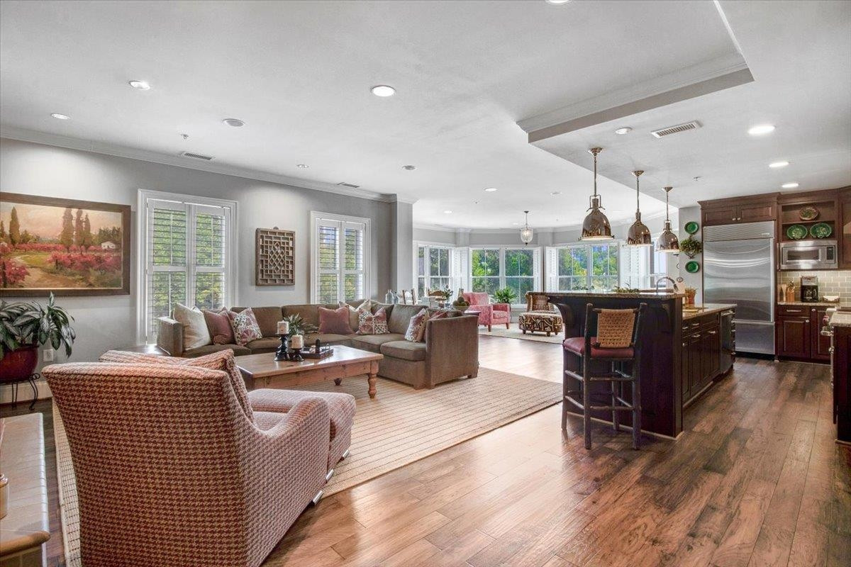 710 Independence Place, Unit 406 Raleigh, NC 27603 - Photo 13 of 50 a living room with furniture kitchen view and large windows