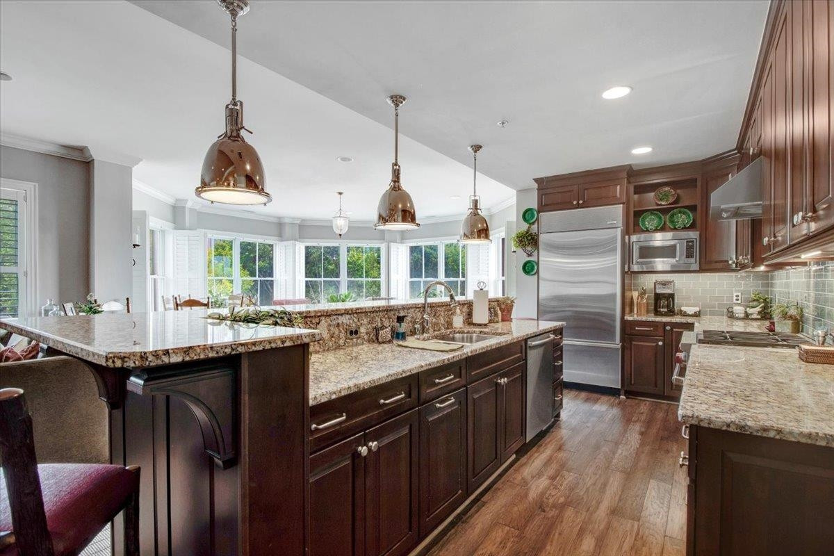 710 Independence Place, Unit 406 Raleigh, NC 27603 - Photo 14 of 50 a kitchen with granite countertop a sink a counter top space stainless steel appliances and a window