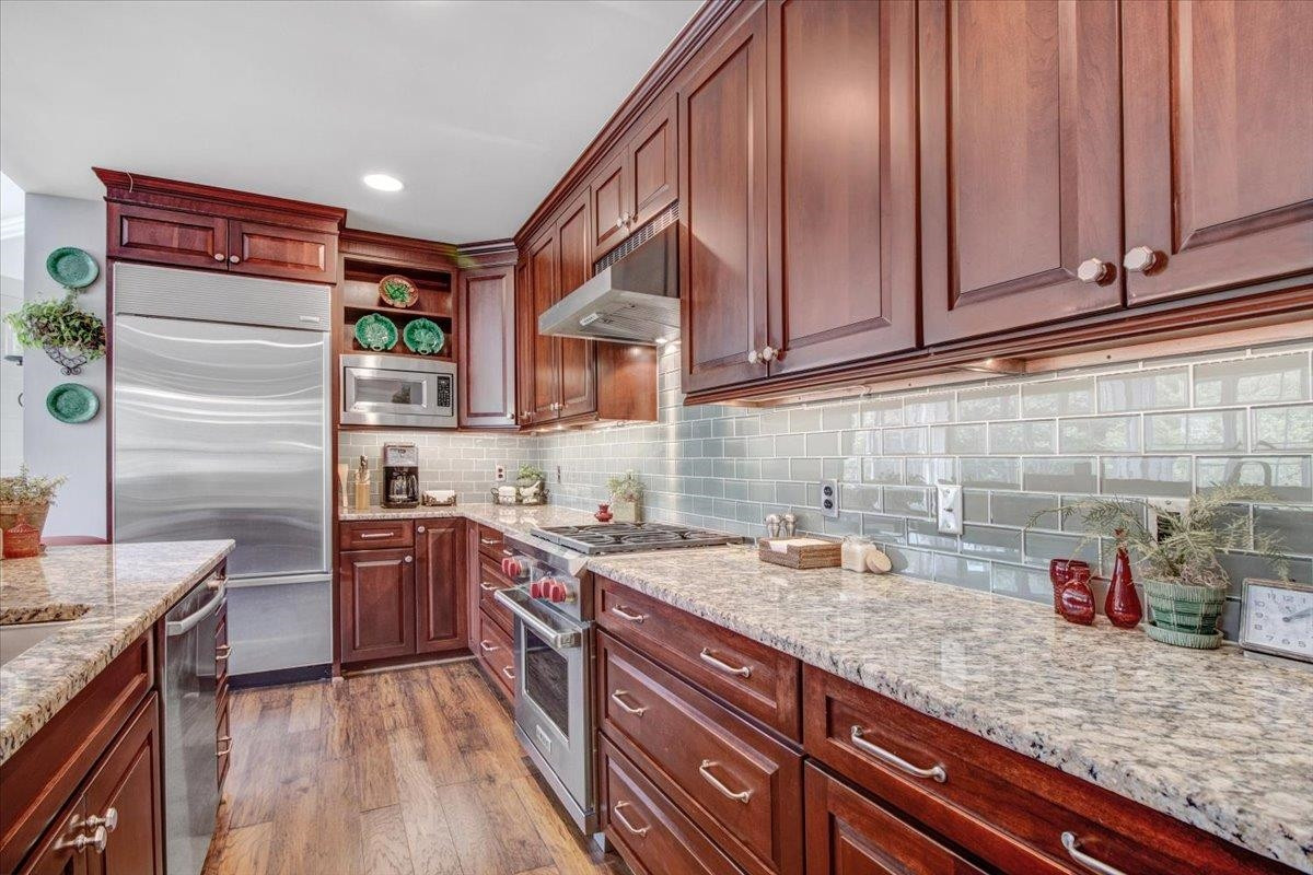 710 Independence Place, Unit 406 Raleigh, NC 27603 - Photo 16 of 50 a kitchen with granite countertop cabinets stainless steel appliances a sink and counter space