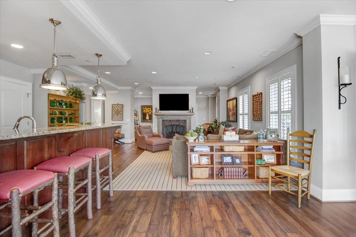 710 Independence Place, Unit 406 Raleigh, NC 27603 - Photo 22 of 50 a living room with fireplace furniture and a wooden floor