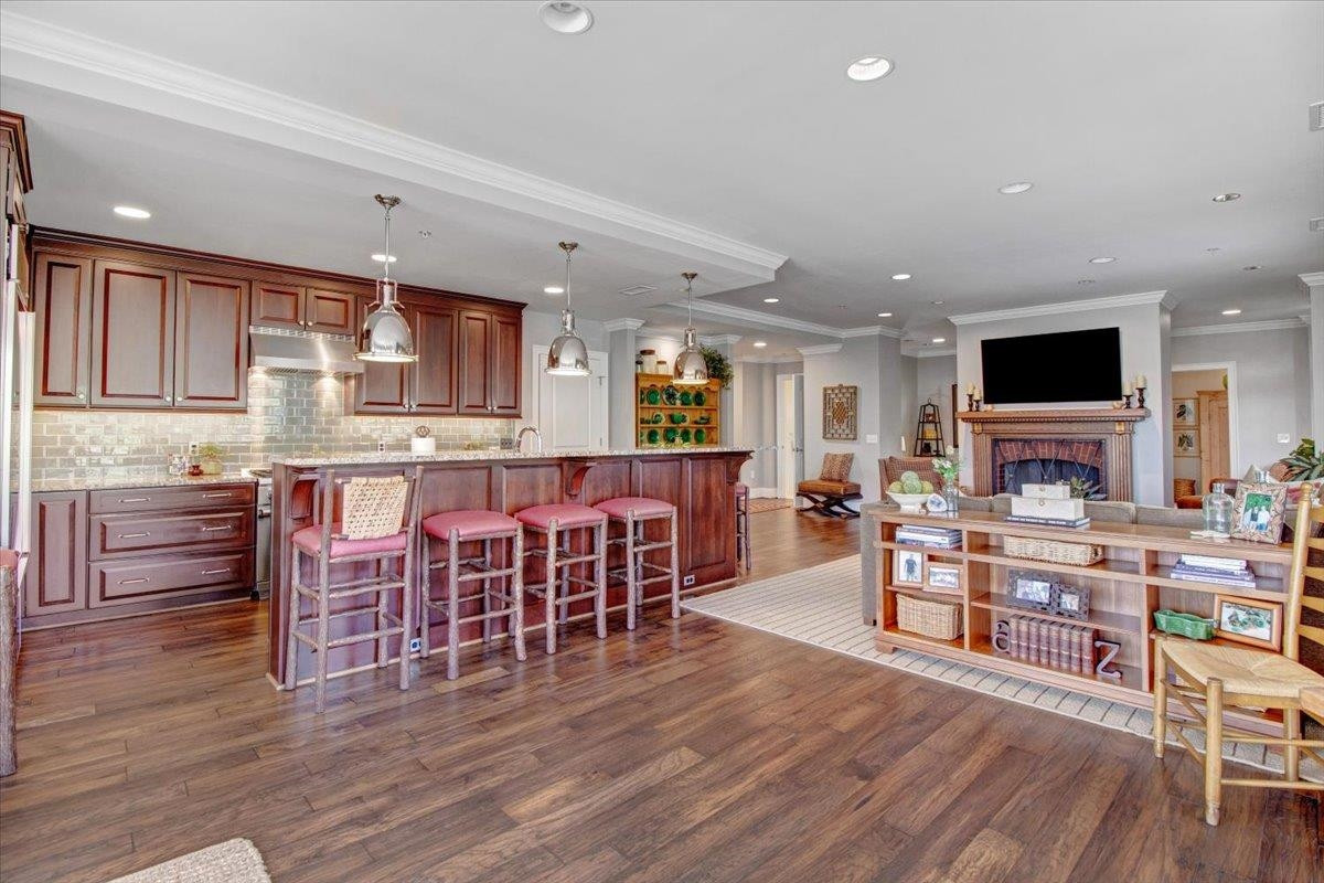 710 Independence Place, Unit 406 Raleigh, NC 27603 - Photo 23 of 50 a living room with stainless steel appliances furniture and a wooden floor