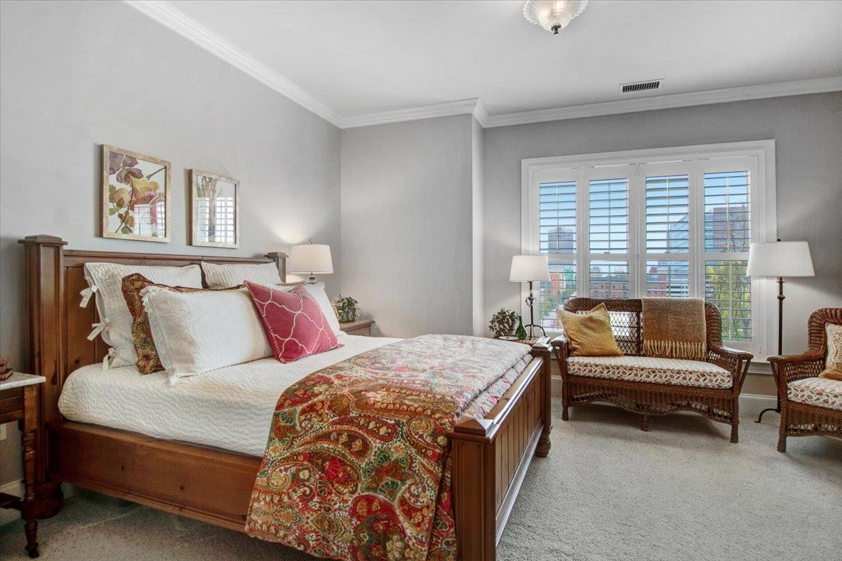 710 Independence Place, Unit 406 Raleigh, NC 27603 - Photo 32 of 50 a bedroom with a bed and a couch