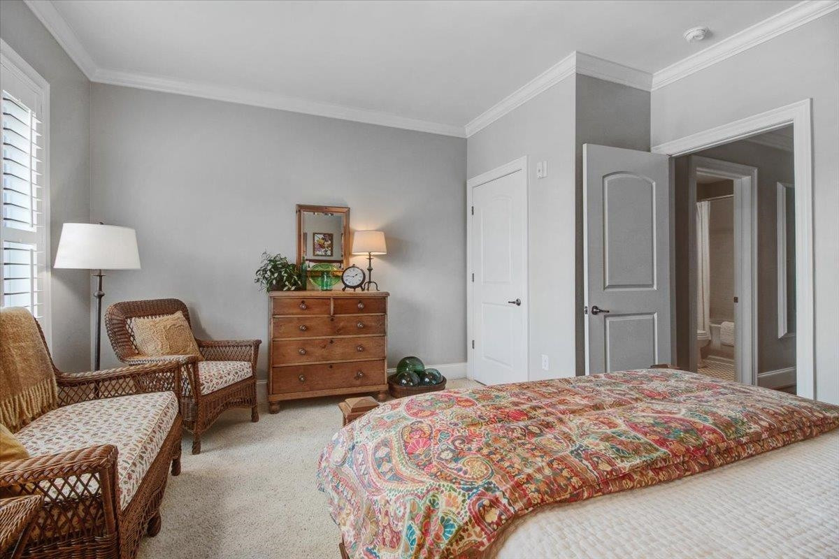 710 Independence Place, Unit 406 Raleigh, NC 27603 - Photo 34 of 50 a bedroom with a bed and furniture