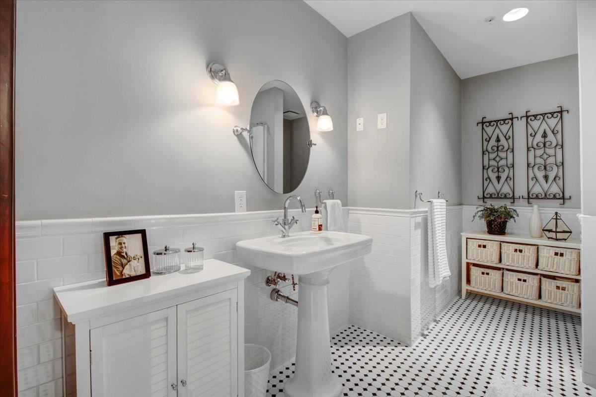 710 Independence Place, Unit 406 Raleigh, NC 27603 - Photo 38 of 50 a bathroom with a sink a mirror and a shower
