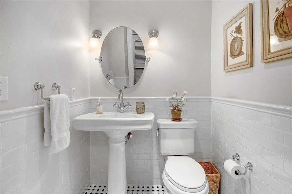 710 Independence Place, Unit 406 Raleigh, NC 27603 - Photo 43 of 50 a bathroom with a toilet a sink and mirror
