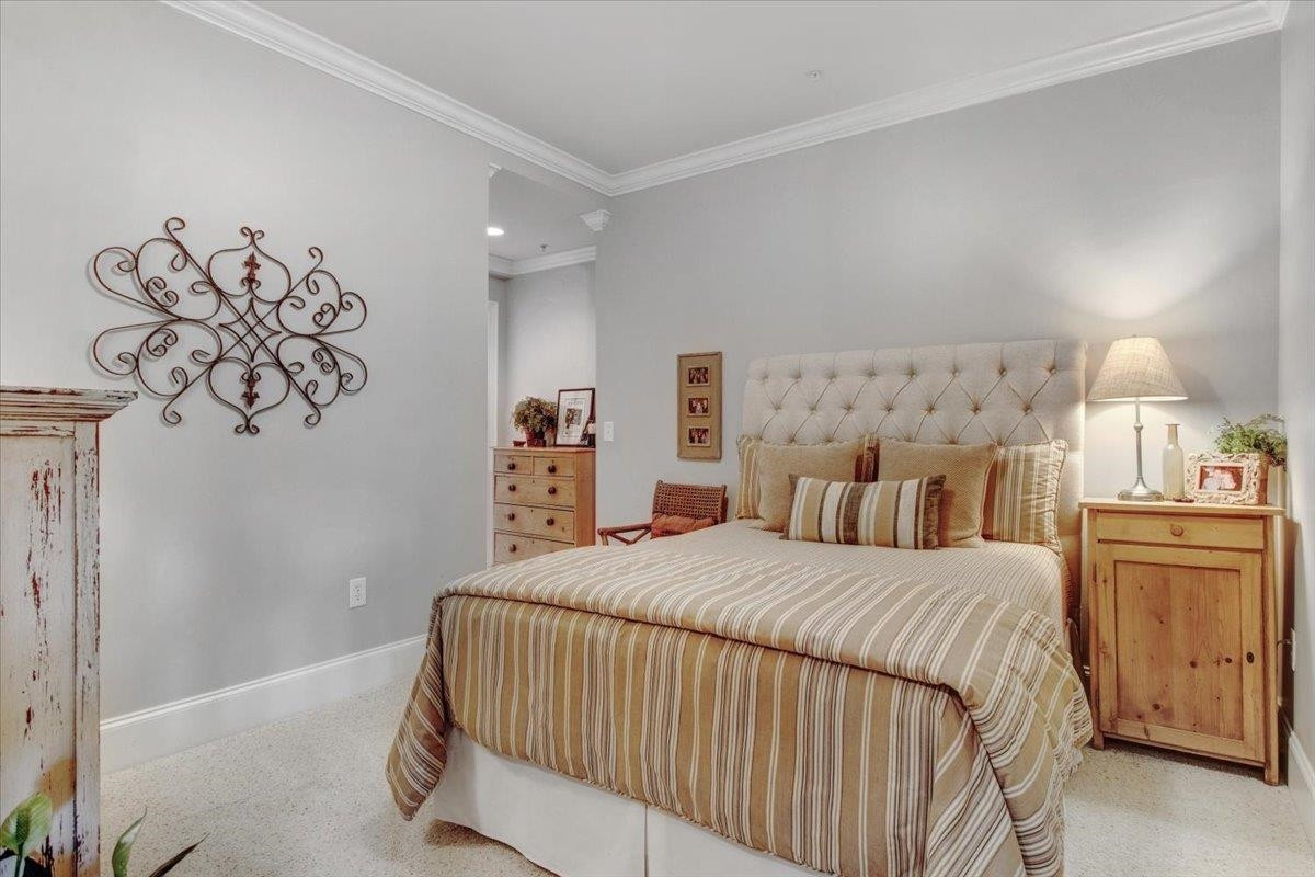 710 Independence Place, Unit 406 Raleigh, NC 27603 - Photo 44 of 50 a bedroom with a bed and painting on the wall