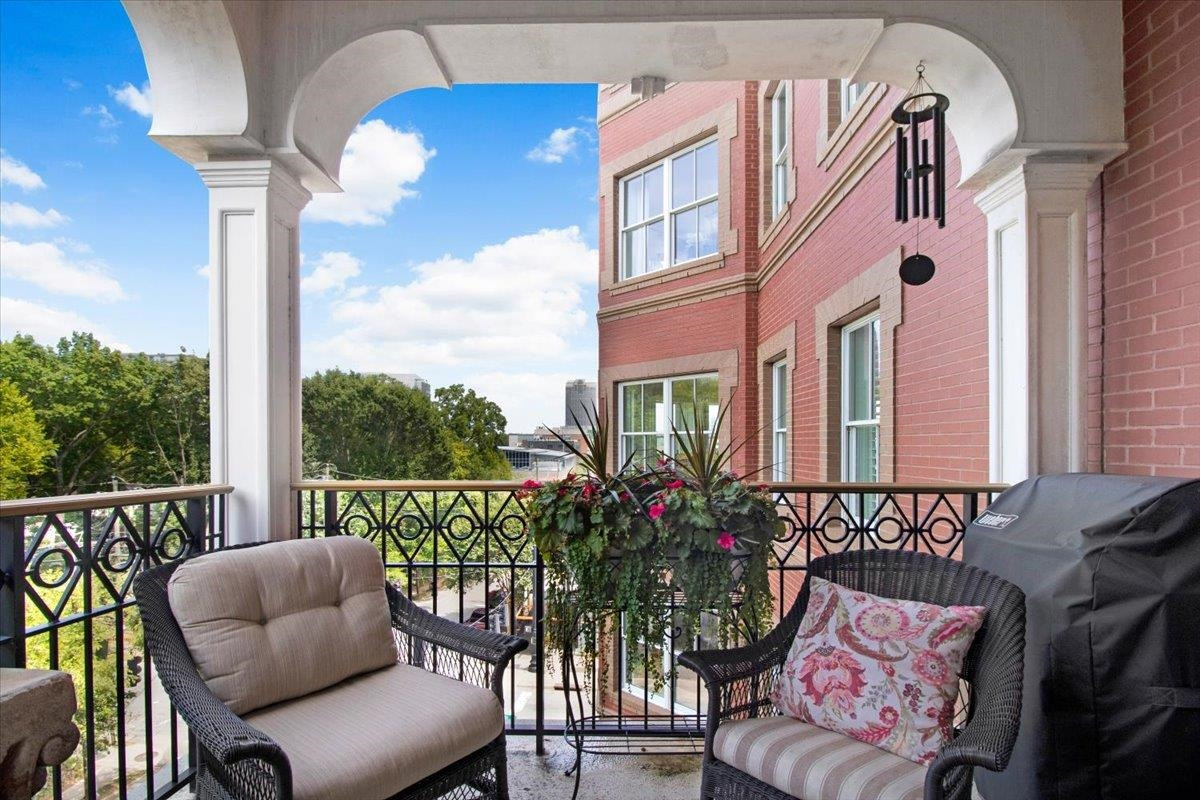 710 Independence Place, Unit 406 Raleigh, NC 27603 - Photo 49 of 50 a balcony view with couple of chairs and potted plants