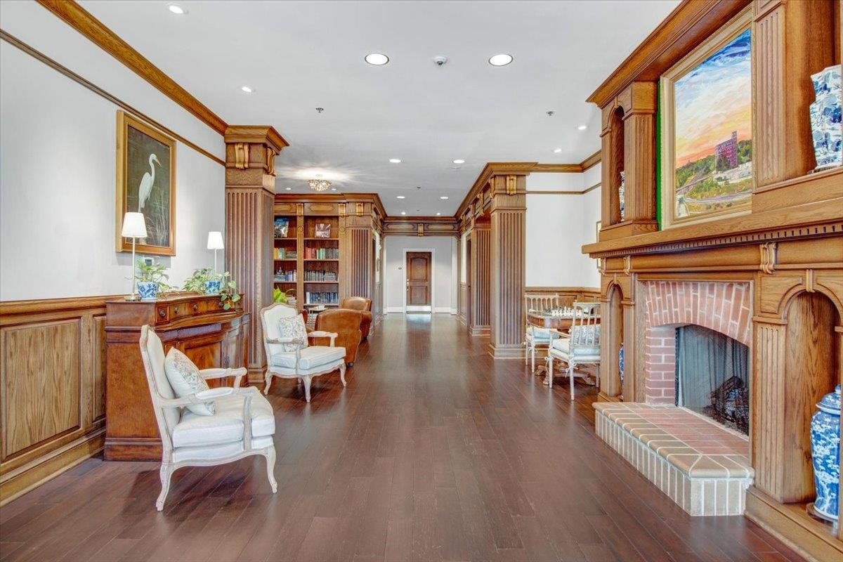 710 Independence Place, Unit 406 Raleigh, NC 27603 - Photo 5 of 50 a living room with furniture a fireplace and wooden floor