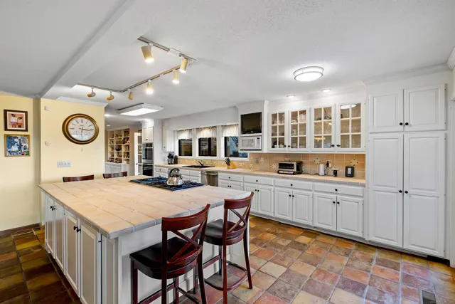 a kitchen with a dining table and chairs