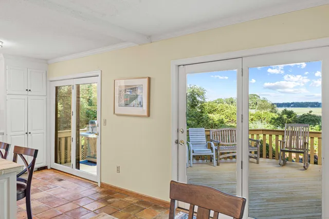 a view of a livingroom with wooden floor and furniture
