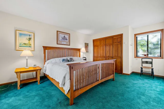 a bed room with a bed and a chair