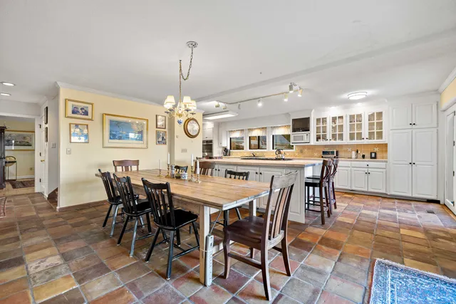 a dining room with a table and chairs