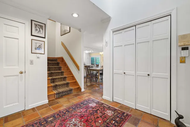 a view of entryway with wooden floor and stairs