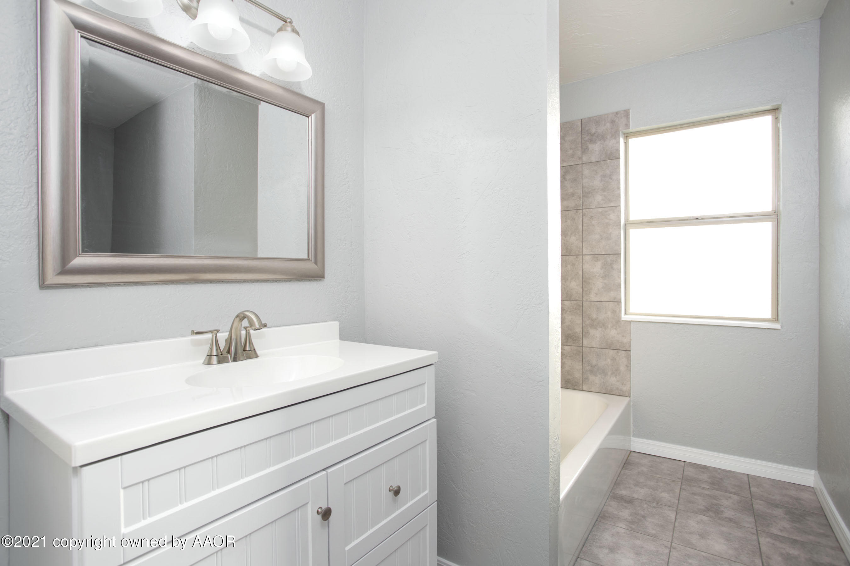 4622 South Rusk Street Amarillo, TX 79110 - Photo 13 of 22 a bathroom with a sink a vanity and a mirror