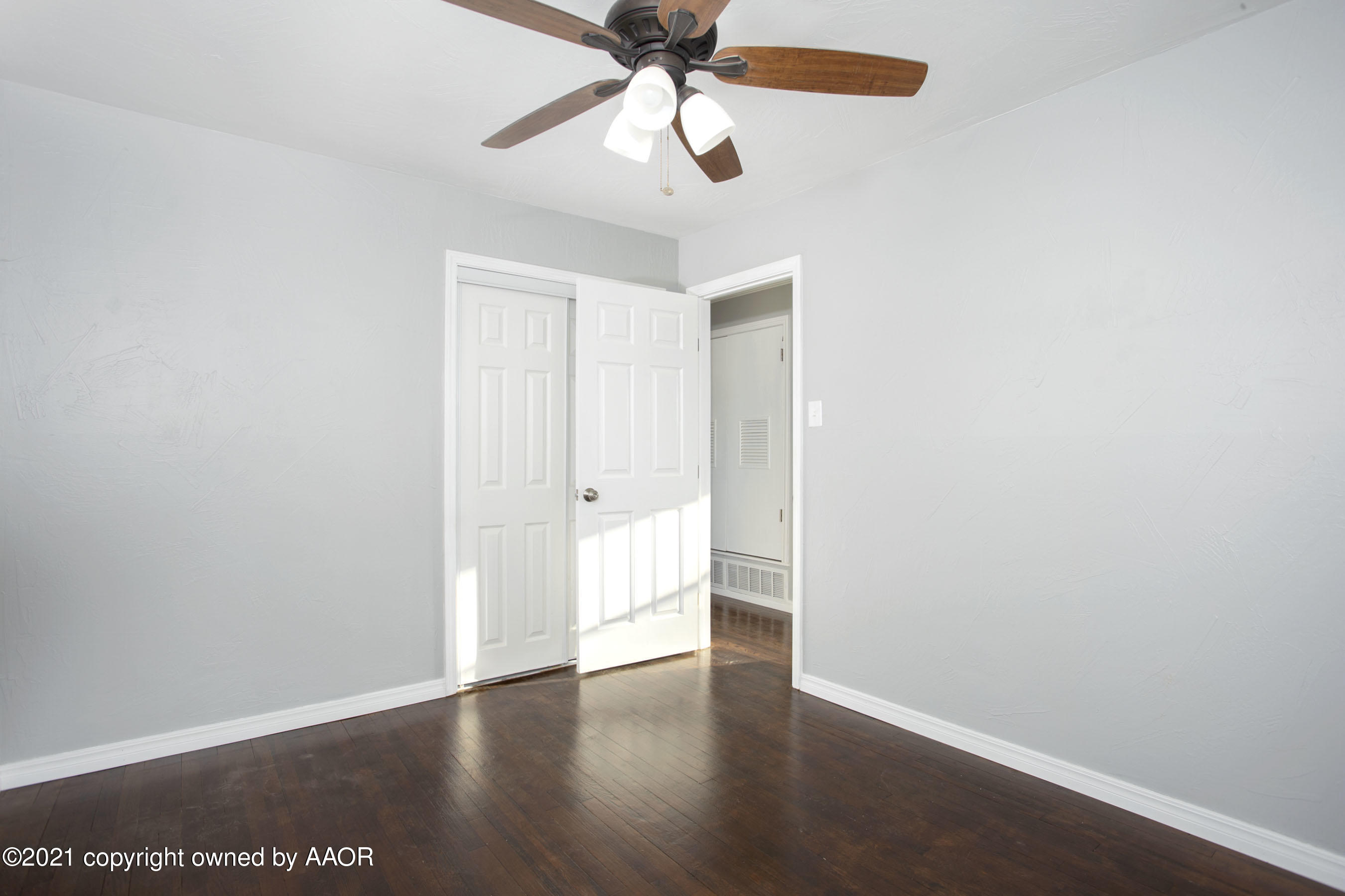4622 South Rusk Street Amarillo, TX 79110 - Photo 16 of 22 a view of an empty room with window and wooden floor