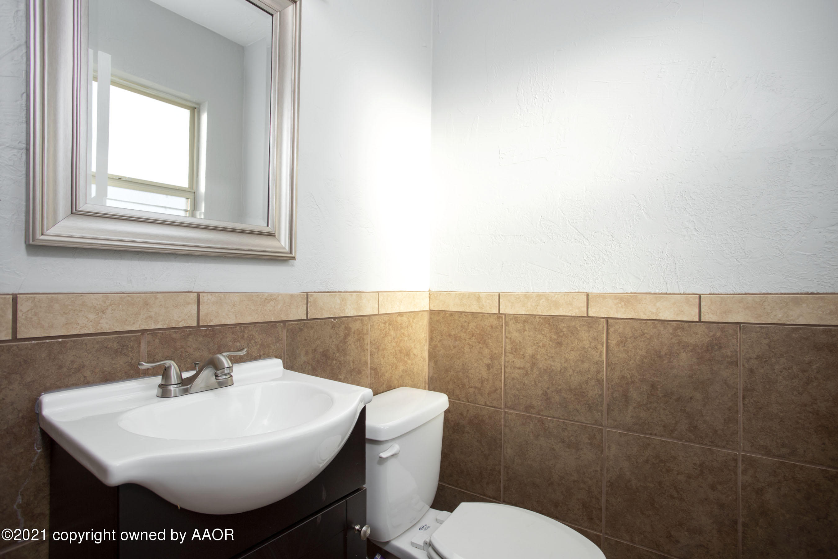 4622 South Rusk Street Amarillo, TX 79110 - Photo 19 of 22 a bathroom with a sink mirror and toilet