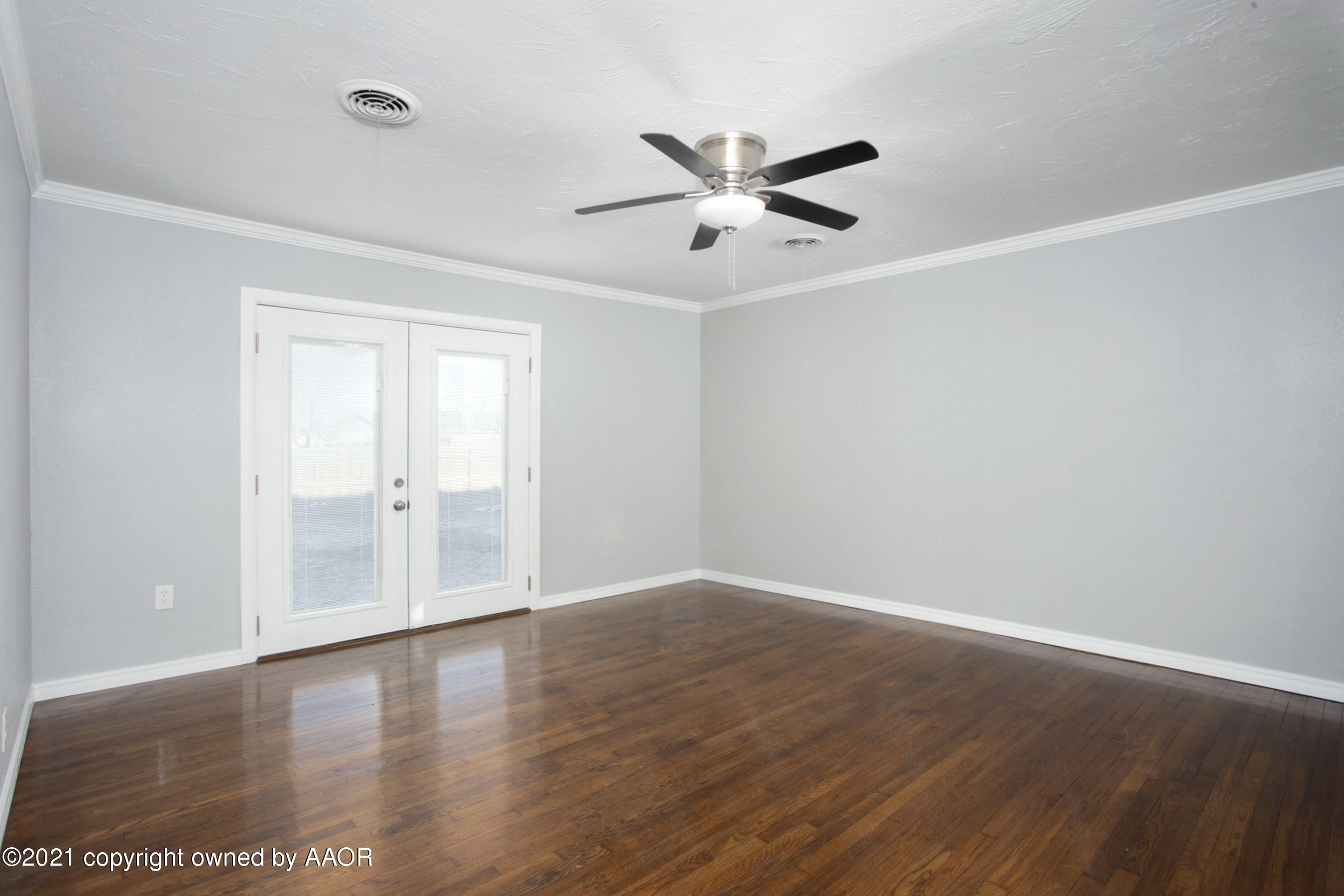 4622 South Rusk Street Amarillo, TX 79110 - Photo 3 of 22 a view of an empty room with wooden floor