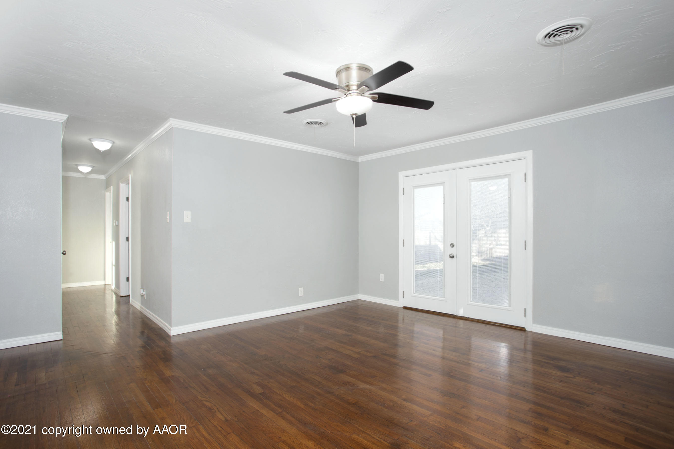 4622 South Rusk Street Amarillo, TX 79110 - Photo 4 of 22 a view of an empty room with wooden floor