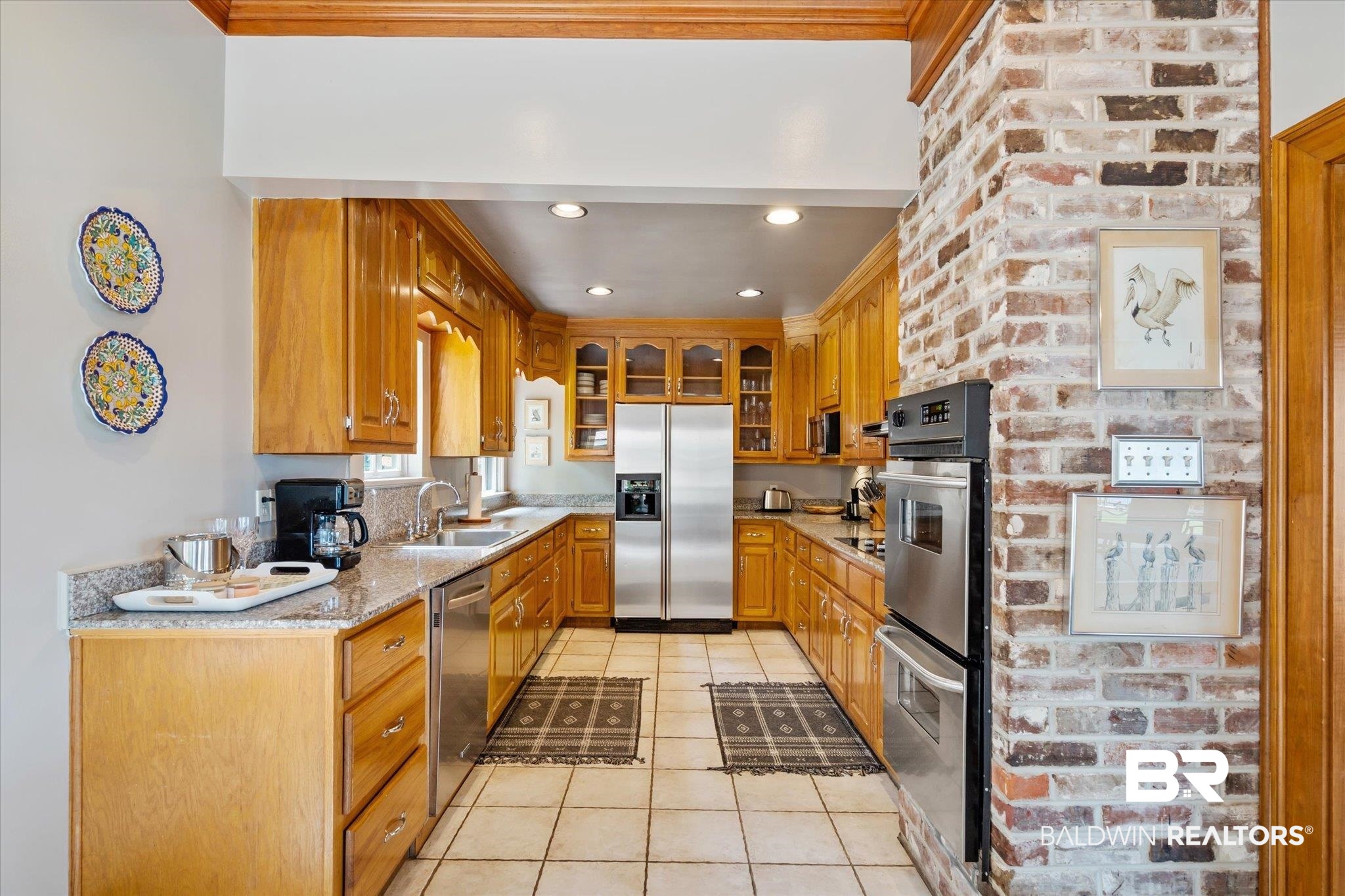 2228 Riverside Drive Mobile, AL 36605 - Photo 17 of 51 Kitchen with light stone countertops, light tile patterned floors, stainless steel appliances, and sink