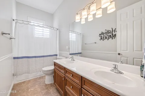 a spacious bathroom with a sink a mirror and a shower