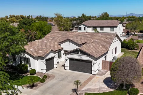 an aerial view of a house with a yard