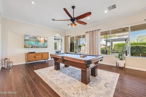 a room with pool table and windows