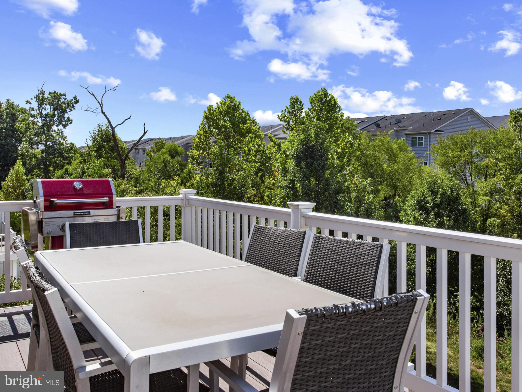 2762 Lady Slipper Road Gambrills, MD 21054 - Photo 12 of 43 a view of a patio with table and chairs with wooden floor and fence