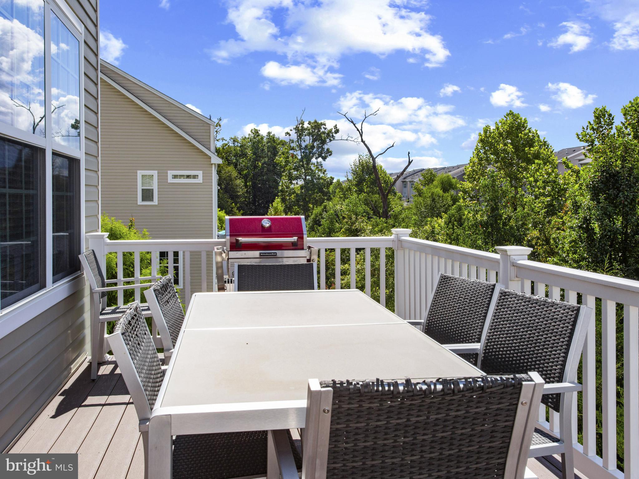 2762 Lady Slipper Road Gambrills, MD 21054 - Photo 13 of 43 a view of a patio with table and chairs with wooden floor and fence