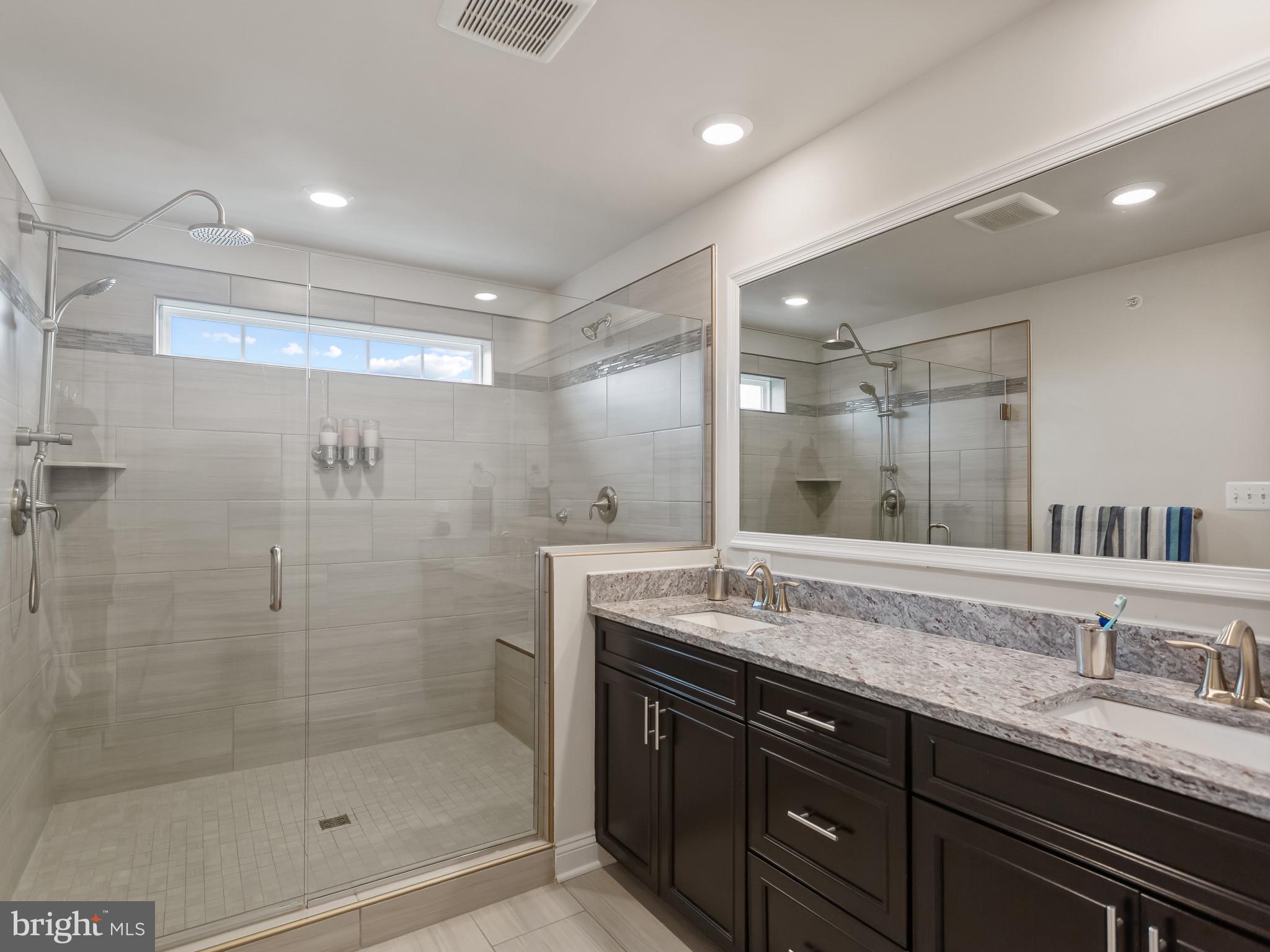 2762 Lady Slipper Road Gambrills, MD 21054 - Photo 19 of 43 a bathroom with a granite countertop sink mirror and shower