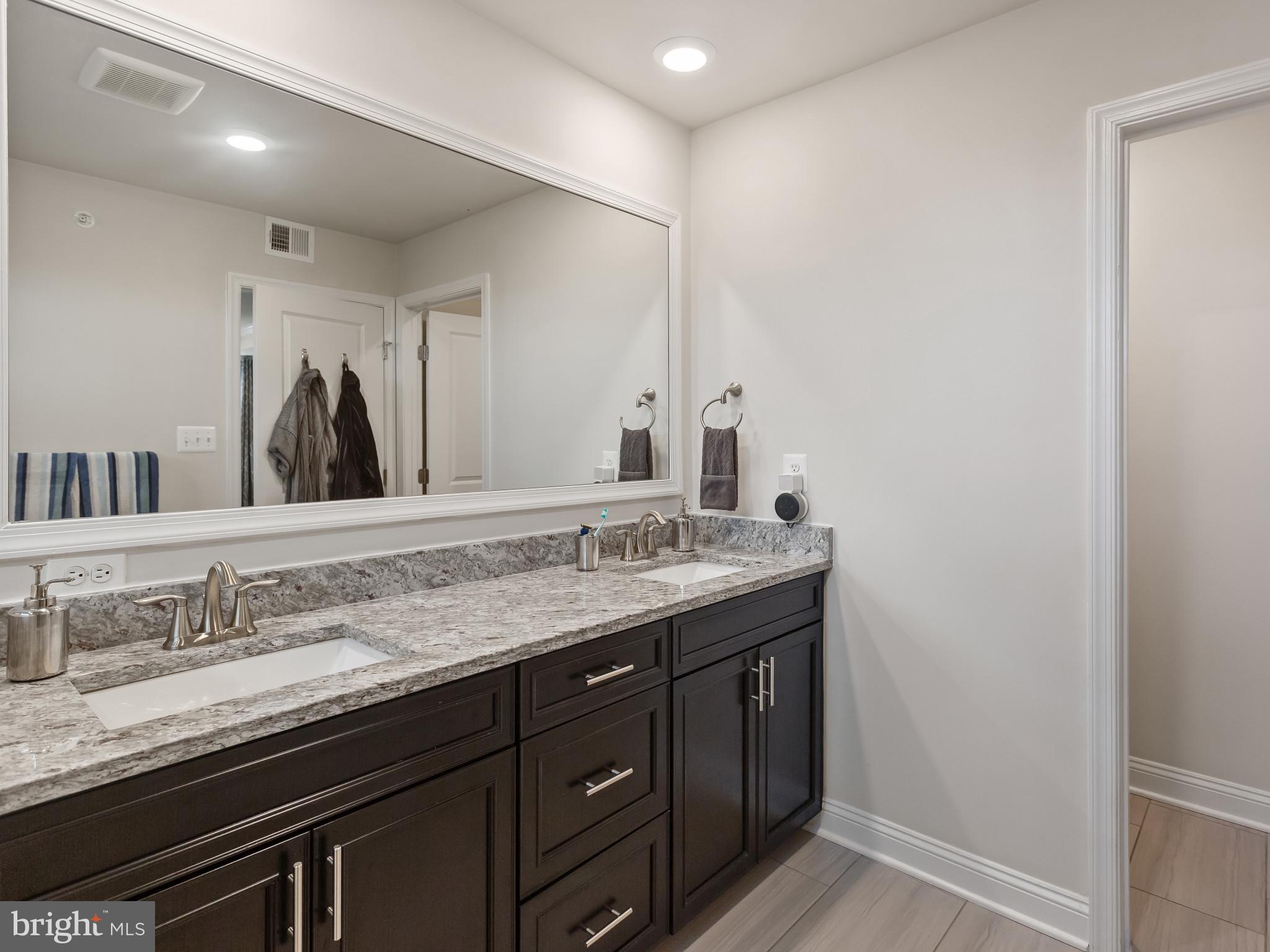 2762 Lady Slipper Road Gambrills, MD 21054 - Photo 20 of 43 a bathroom with a granite countertop sink and a large mirror