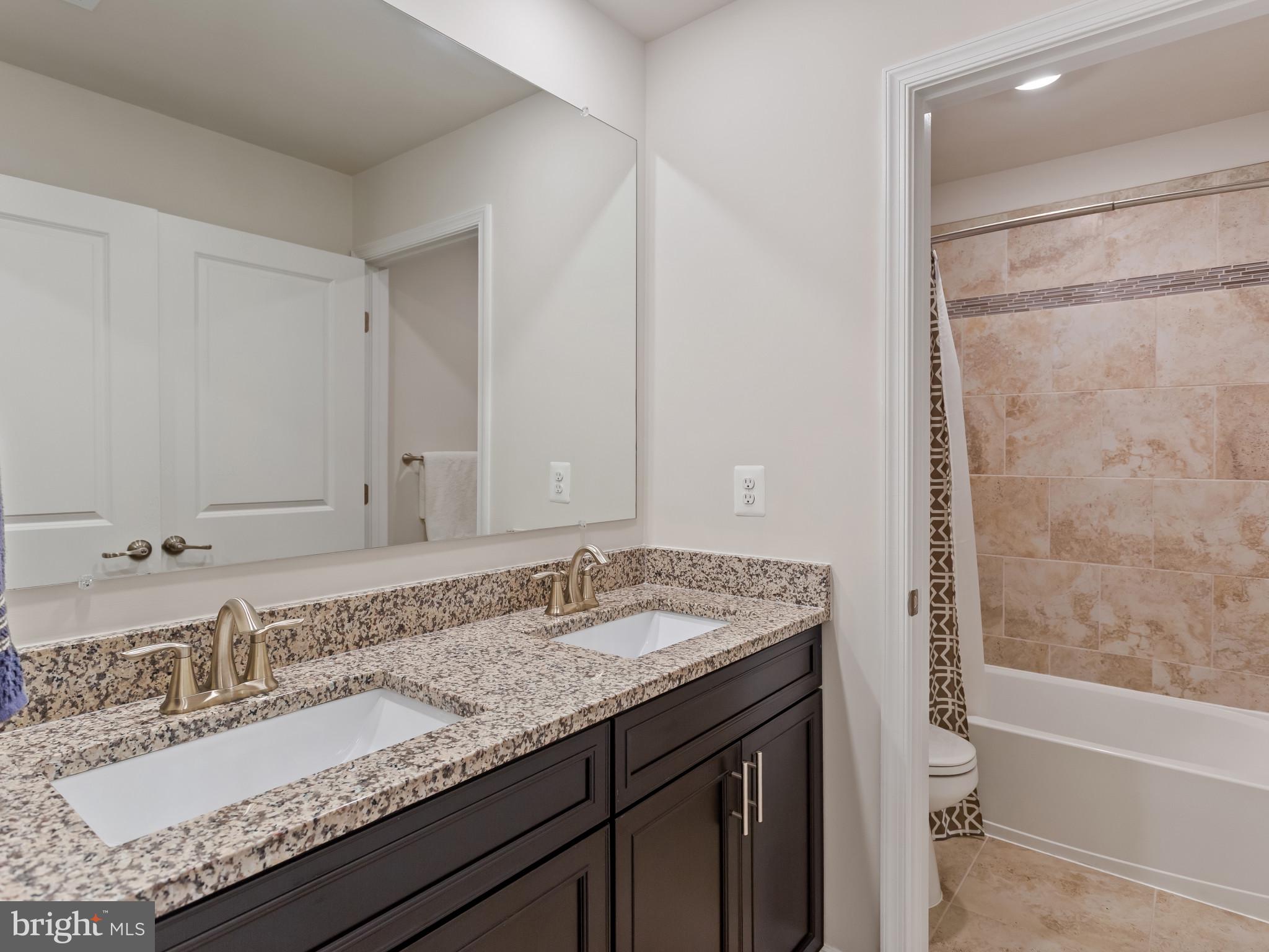 2762 Lady Slipper Road Gambrills, MD 21054 - Photo 24 of 43 a bathroom with a granite countertop sink and a mirror