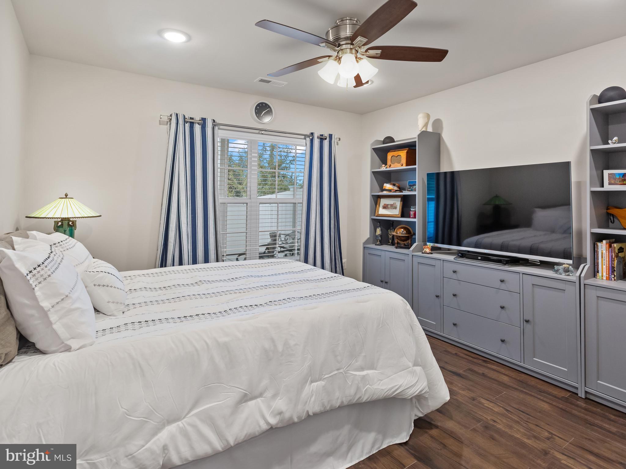 2762 Lady Slipper Road Gambrills, MD 21054 - Photo 31 of 43 a bedroom with a large bed and a flat screen tv