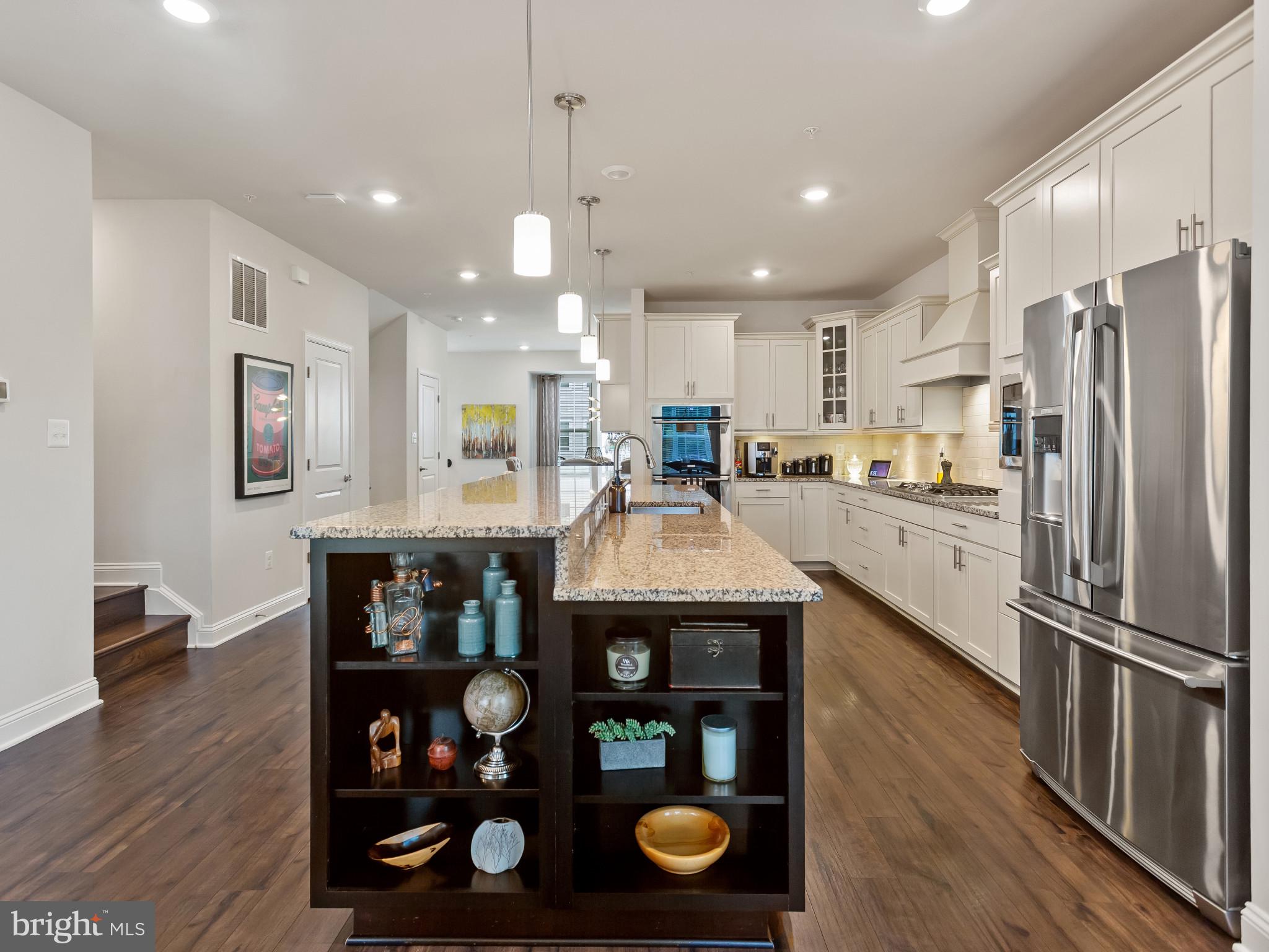 2762 Lady Slipper Road Gambrills, MD 21054 - Photo 6 of 43 a kitchen with stainless steel appliances granite countertop a refrigerator a stove and a wooden floors