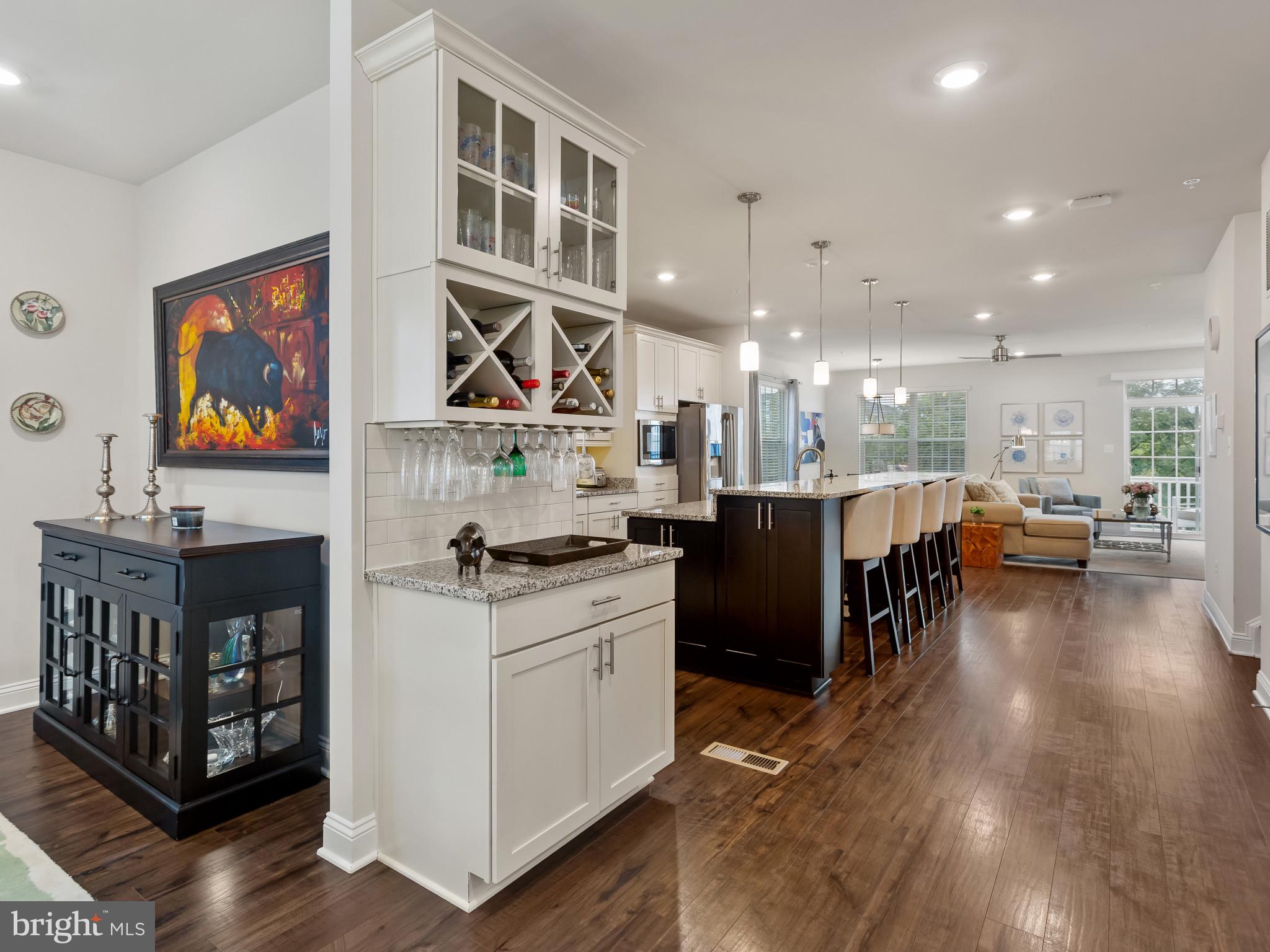 2762 Lady Slipper Road Gambrills, MD 21054 - Photo 7 of 43 a open kitchen with stainless steel appliances kitchen island granite countertop a stove and a refrigerator